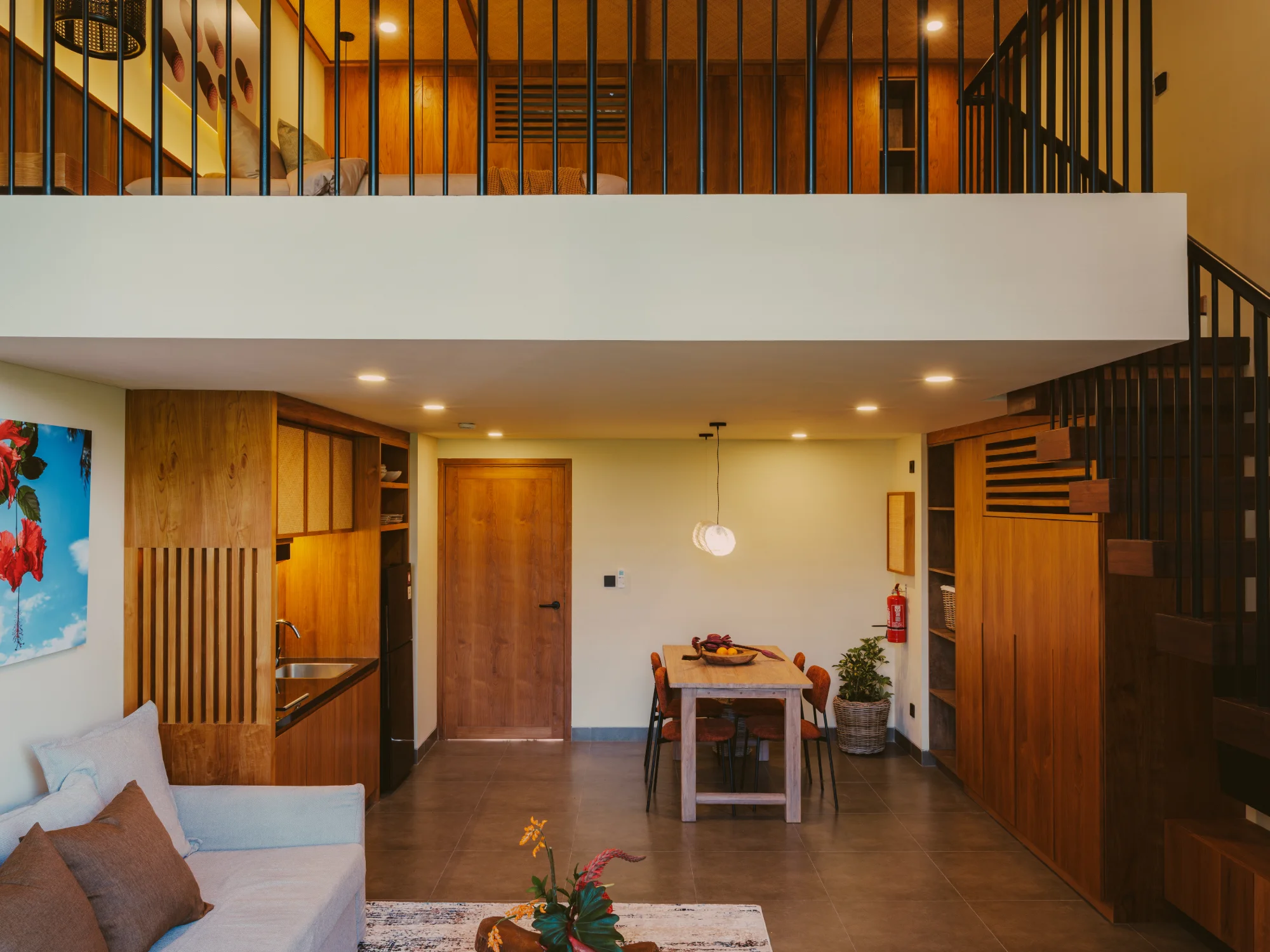 Deluxe mezzanine duplex suite with double-height ceiling and comfortable lounge
