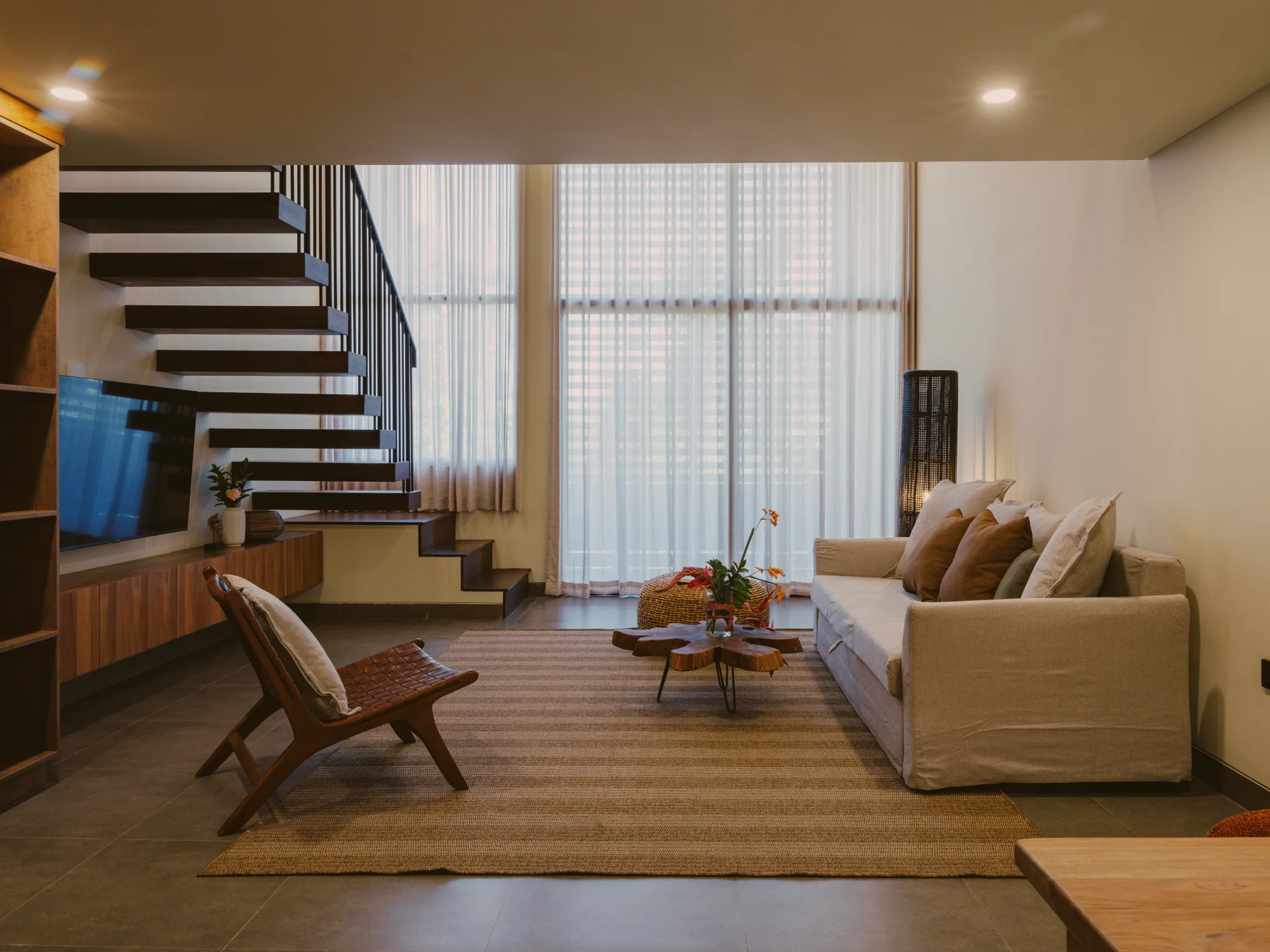 Wide angle perspective of the duplex living room and mezzanine ceiling